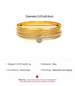 Detail of 10-piece gold alloy bangle set showing diamond-cut patterns and rhinestone inlay