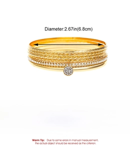 Detail of 10-piece gold alloy bangle set showing diamond-cut patterns and rhinestone inlay