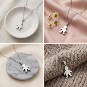 Macro detail of polished silver boy charm pendant on stainless steel cross chain necklace