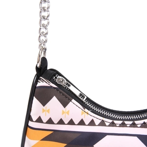 Close-up of bohemian handbag with geometric pattern, silver chain, and zipper closure