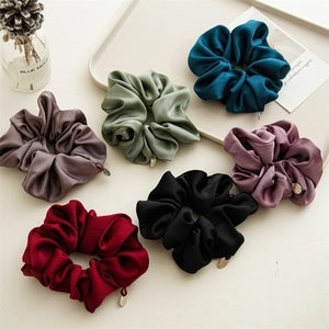 Set of six premium satin scrunchies in various colors with elegant metal charms