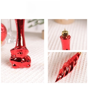 Detail showing shiny red metallic Christmas ornaments with mushroom and spiral shapes