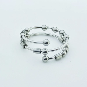 Close-up of stainless steel fidget ring featuring movable beads and spiral band