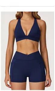 Detail of midnight blue yoga sports bra with cross back design and v-neckline
