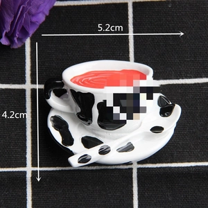 Miniature tea cup and saucer set with cow print and red filling for DIY crafts