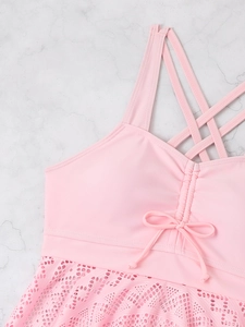 Pink two-piece swimdress detail with hollow lace hem and crisscross back straps