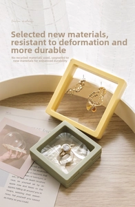 Detailed view of yellow and green PE film floating jewelry cases with rings and earrings