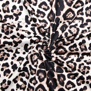 Detailed close-up showing soft leopard print fabric texture and smooth polyester material