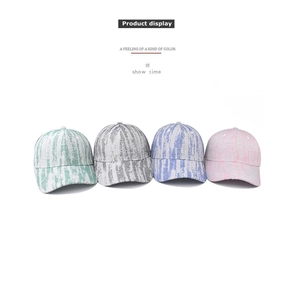 Detailed row of striped baseball caps in green, grey, blue, and pink tweed fabric