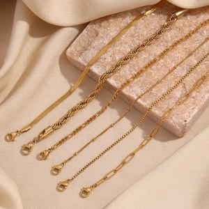 Selection of six 18K gold plated stainless steel chains on soft beige silk background