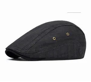 Close-up of black plaid newsboy cap with golden metal side eyelets and woven texture