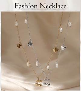 Detailed shot of gold and silver necklaces with pearl, rose, heart and cherry pendants