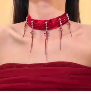 Detail of red velvet choker with rhinestone crosses and metallic tassel fringe necklaces