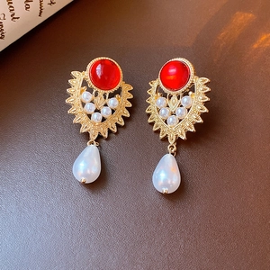 Elegant gold drop earrings with red ruby, pearls and a teardrop pearl on leather
