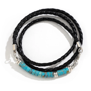 Close-up of multi-layer braided leather bracelet with turquoise stones and silver metal spacers
