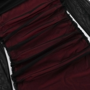 Detail of elegant ruched mesh fabric on a burgundy and black off-shoulder slim dress