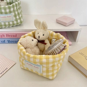 Detailed view of yellow checkered cotton storage basket with Sorakka Studio label