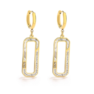 Macro shot of gold-plated earrings with mother-of-pearl and cubic zirconia inlay