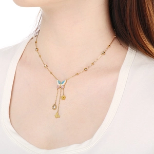 Golden butterfly necklace with colorful enamel, pearl charms, and zircon tassels on a model