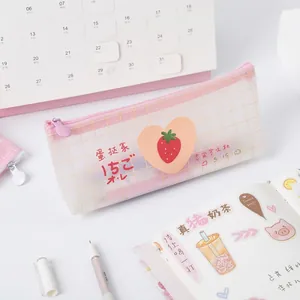 Pink mesh pencil case with strawberry pattern and zipper on a stationery desk setup