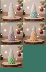 Detail of Christmas tree candles in gradient colors on wooden bases for home decor