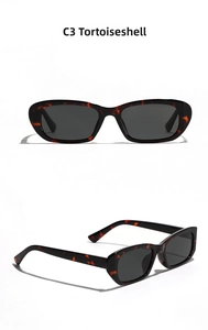Detail view of vintage tortoise shell sunglasses with narrow frames and dark grey lenses