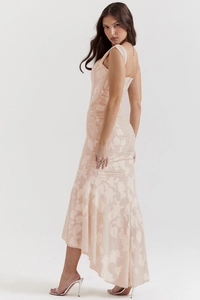 Close-up of peach-pink jacquard dress featuring a corset style and high-low asymmetrical hem