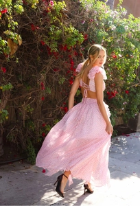 Outdoor shot of a floral backless top and flowing maxi skirt set in warm sunlight