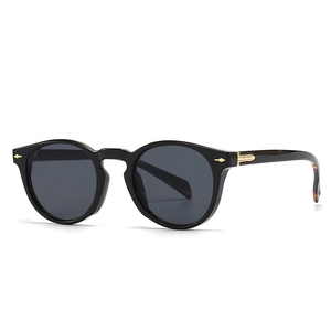 Vintage round black sunglasses with gold arrow details and tortoise temple tips