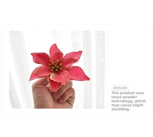 Close-up of 13cm red poinsettia Christmas flower with golden glitter finish details
