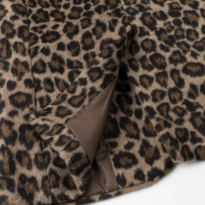 Detailed macro view of the leopard print faux fur fabric and high-quality inner lining
