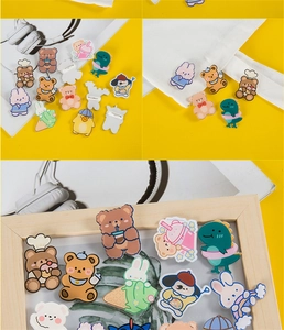 Detailed view of colorful acrylic cartoon pins on canvas bags and decorative scenes