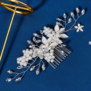 Detail of bridal hair comb with silver flower wire, white pearls and clear rhinestones