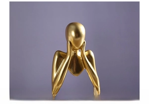 Detail of a golden abstract thinker sculpture showing resin texture and smooth metallic finish