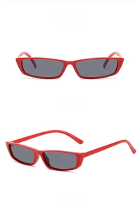 Detail view of stylish red rectangle sunglasses featuring dark grey tinted lenses