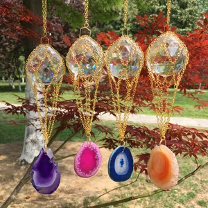 Macro detail of crystal suncatchers with gold mesh wire and colorful agate stone slices