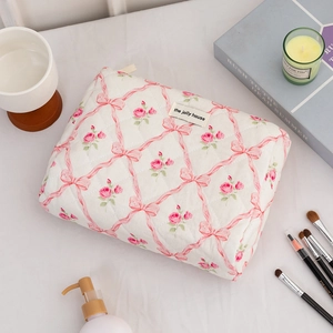 Quilted makeup bag with floral bow print and handle for large capacity storage