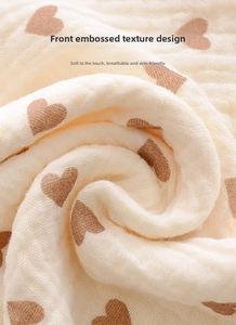 Macro detail of breathable crinkle cotton gauze fabric with brown heart pattern
