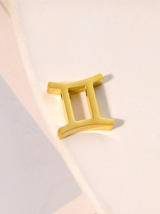 Detailed view of Gemini zodiac sign pendant in polished gold-plated stainless steel