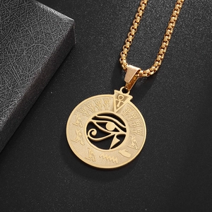 Macro shot of golden Eye of Horus pendant featuring ancient Egyptian hieroglyph symbols
