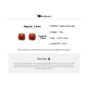 Detail view of red zircon geometric earrings showing exact 1.4cm dimensions and specs