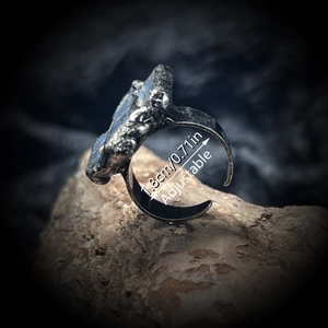 Adjustable raw labradorite stone ring in antique silver finish on natural rock base