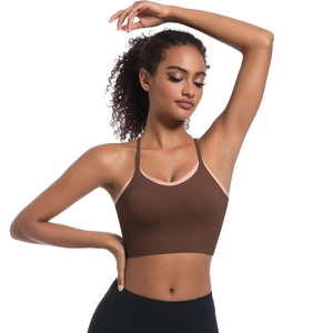 Detail of a brown sports bra with pink piping trim and wide elastic support band