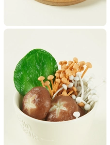 Macro shot of realistic PVC enoki and shiitake mushroom models in a decorative bowl