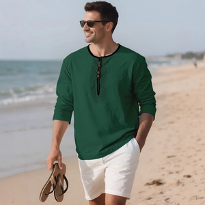 Men's casual deep green linen long sleeve henley shirt shown in a scenic beach setting