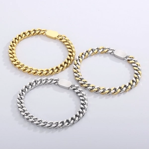 Three Cuban link bracelets in gold, silver and two-tone finishes on a gray background