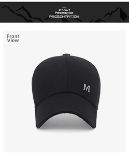 Detail of black cotton canvas baseball cap featuring a silver metallic letter M logo