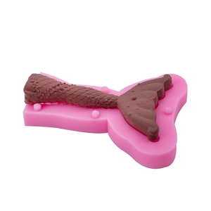 Pink silicone mold and 3D mermaid tail chocolate decoration with detailed scale textures