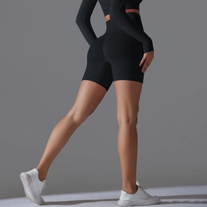Detail of high-waisted seamless yoga shorts in black with peach butt lift shaping effect