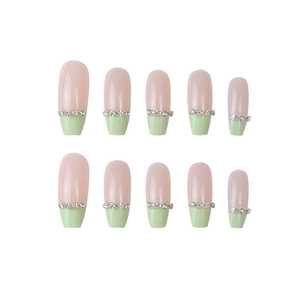 Pink and green French tip coffin press-on nails with silver rhinestones on white background